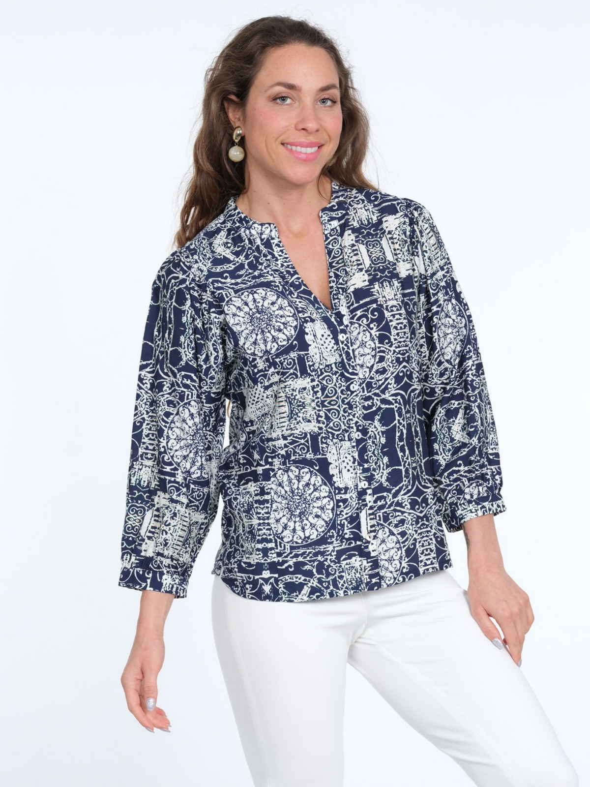 LIOR Joni navy-and-white printed button-front blouse with a split neckline and three-quarter sleeves, styled with white pants.