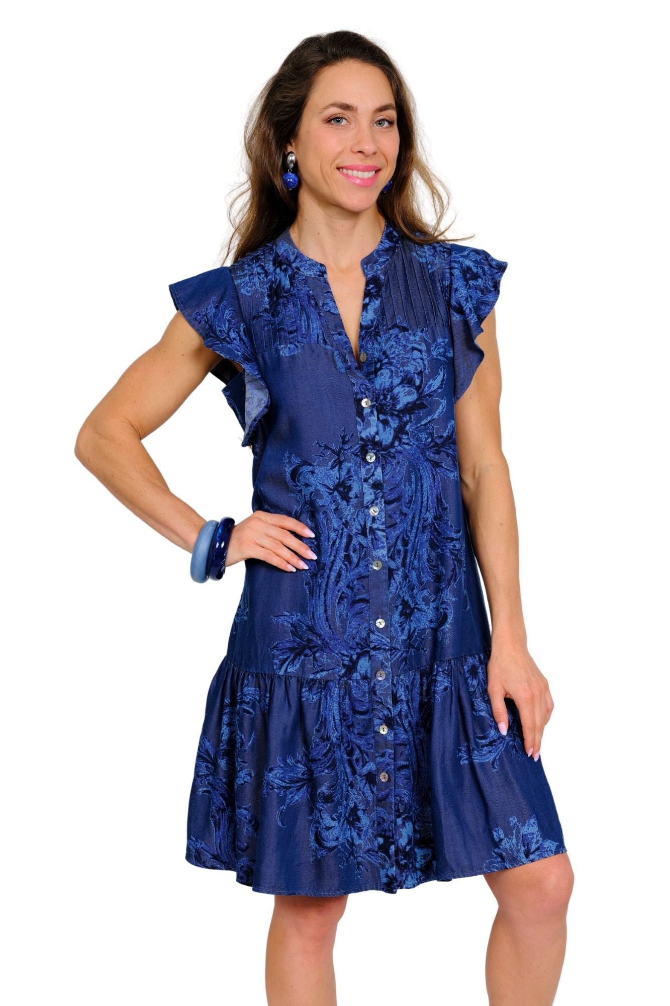 Model wearing LIOR Kelsey navy floral button-front shirt dress with ruffle cap sleeves and tiered skirt
