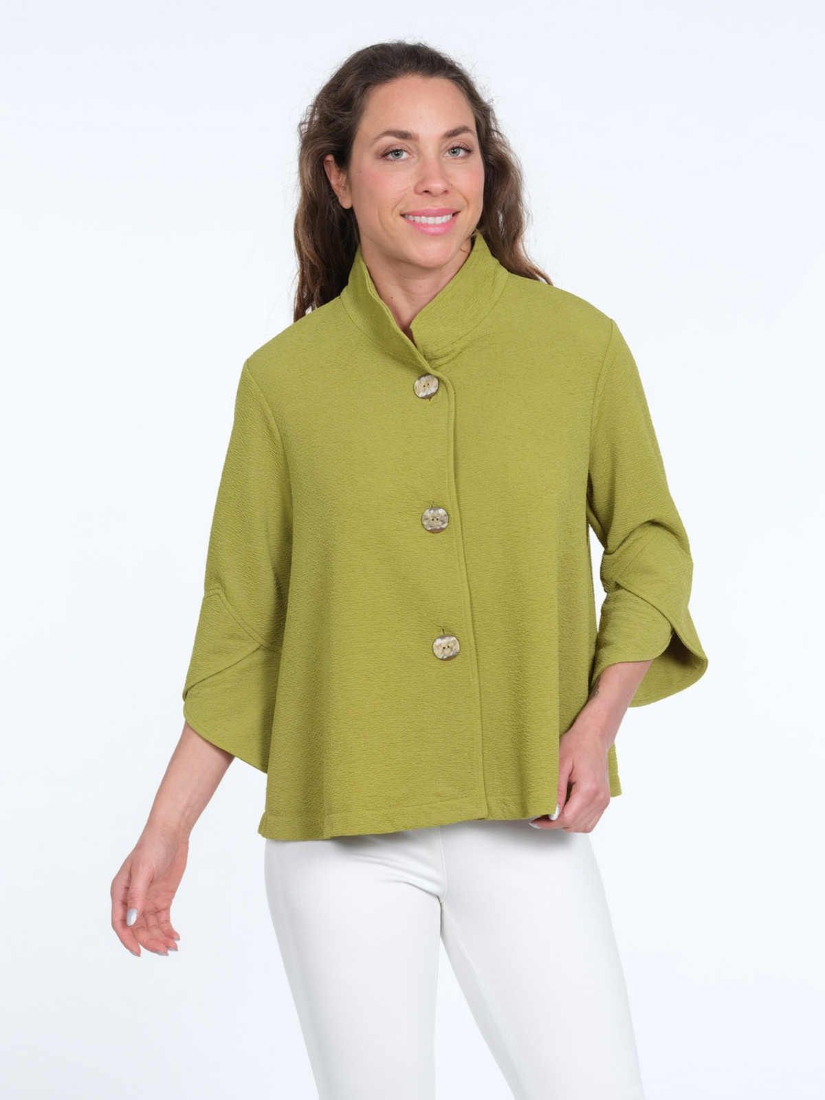 LIOR Vaya lime-green textured jacket with a stand collar, three statement buttons, and three-quarter petal cuffs, styled with white trousers