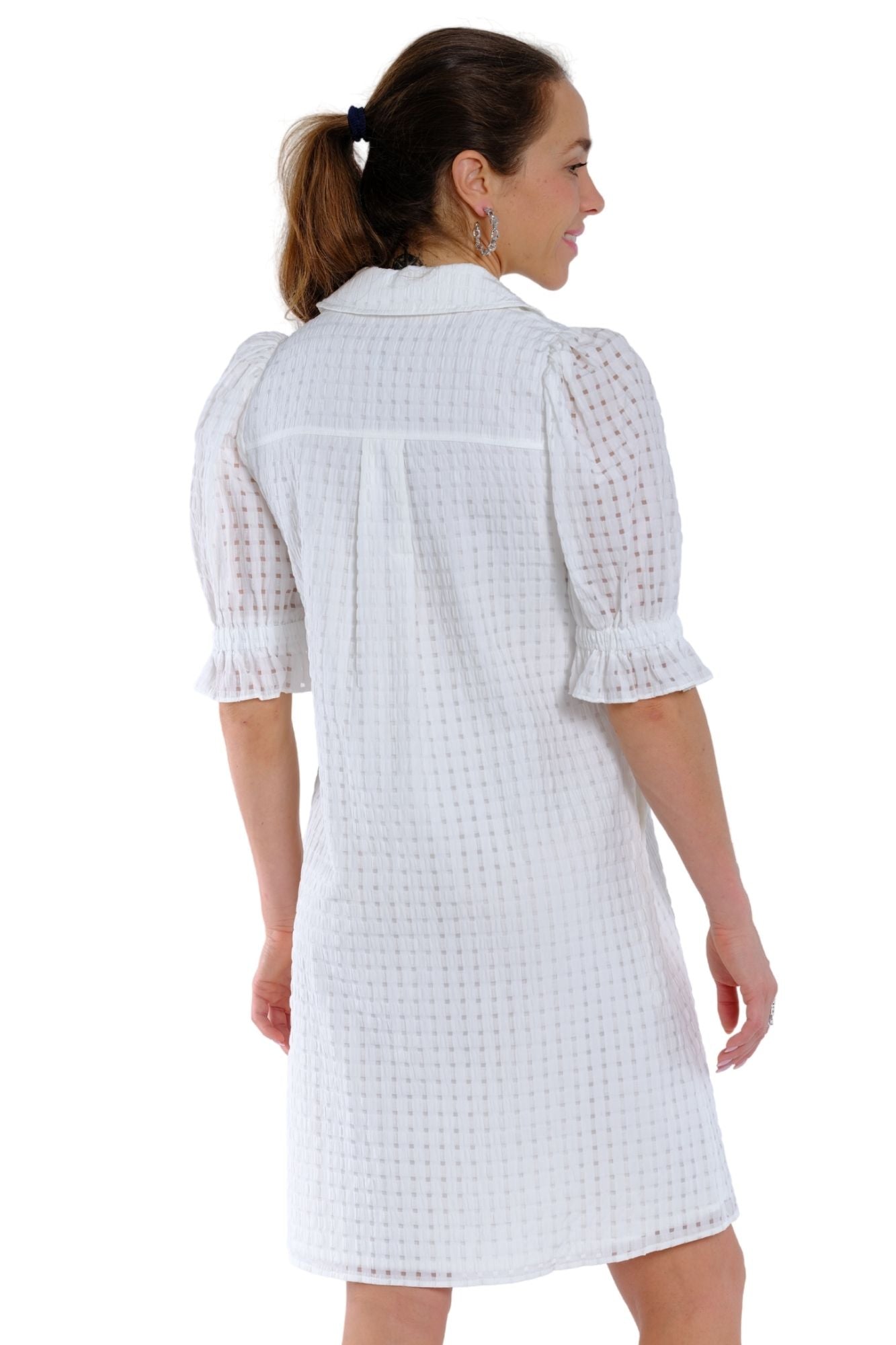 Women’s white travel midi dress by LIOR with puff 3/4 sleeves, smocked cuffs, and utility pockets